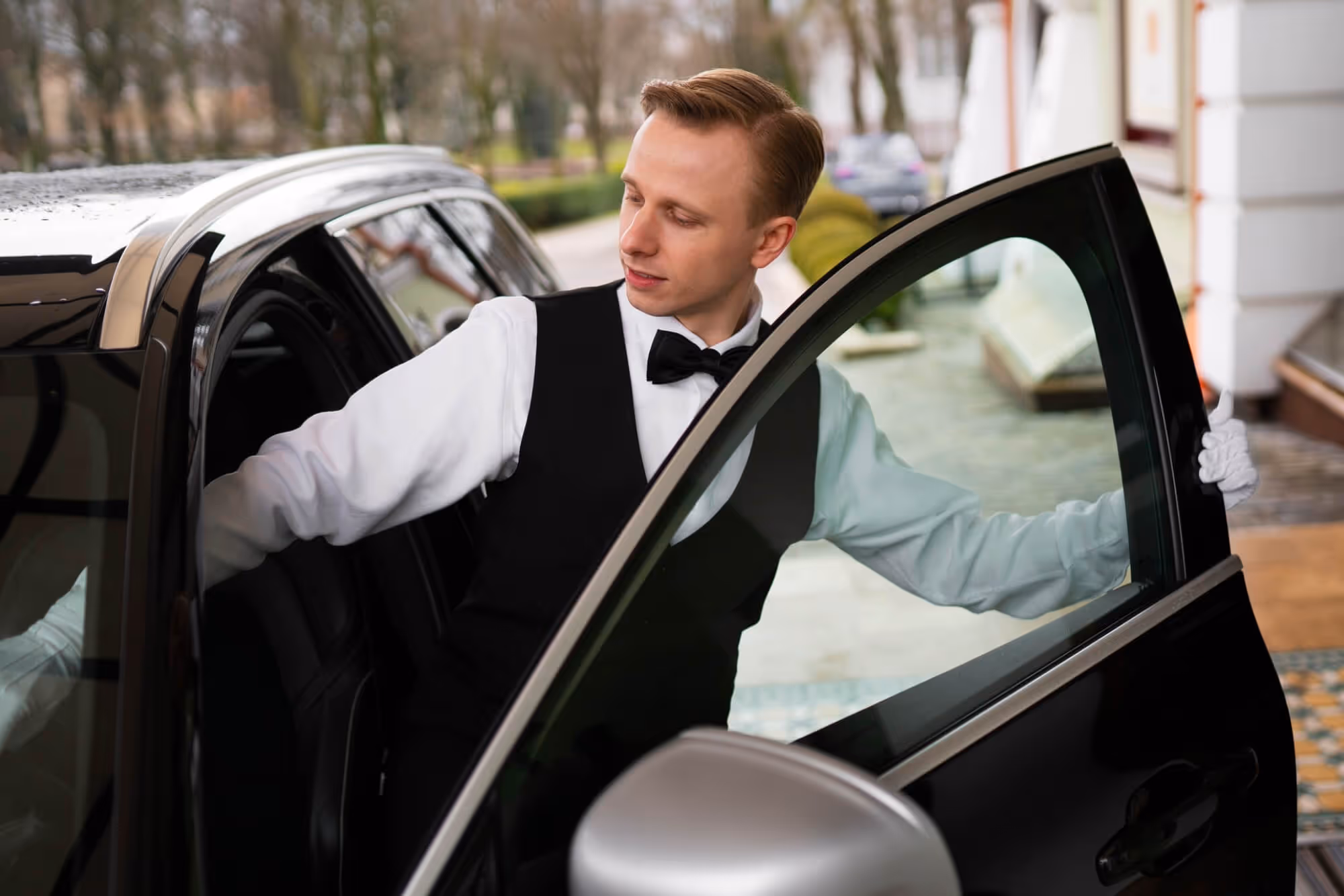 Event transport in Belgrade – a professional chauffeur opens the door for VIP guests